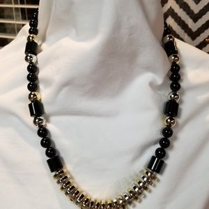 Gold, black and silver necklace.
